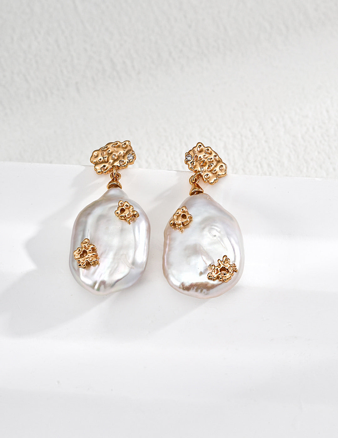 Mira Aura baroque pearl drop earrings with textured gold accents styled to pair with necklaces and pendants