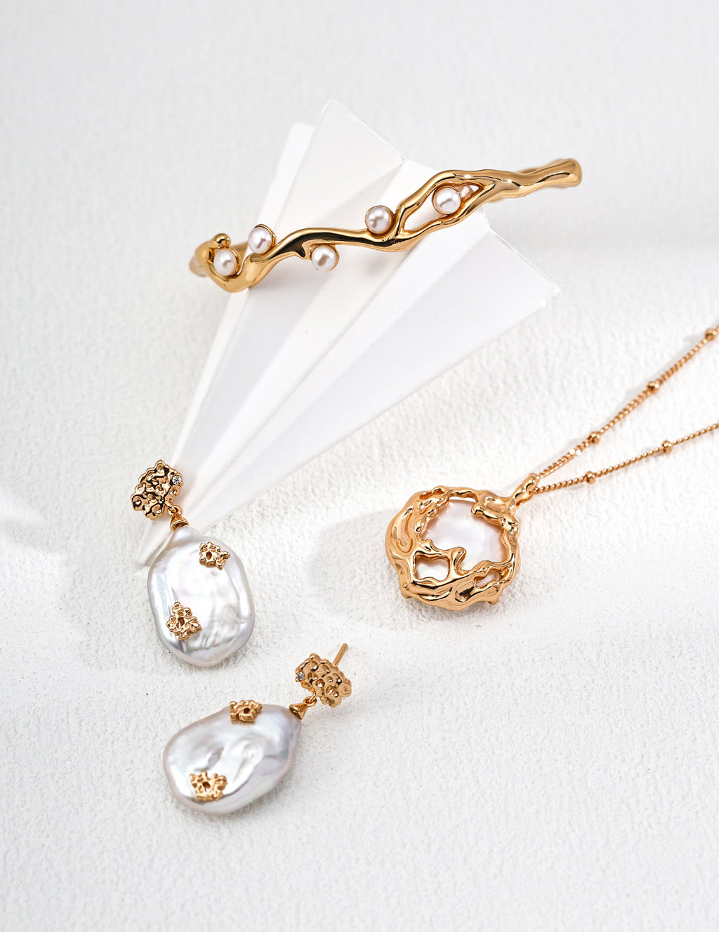 Mira Aura Necklaces and Pendants featuring organic gold pendant double chain baroque pearl drop earrings and branch cuff