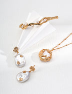 Mira Aura Necklaces and Pendants featuring organic gold pendant double chain baroque pearl drop earrings and branch cuff