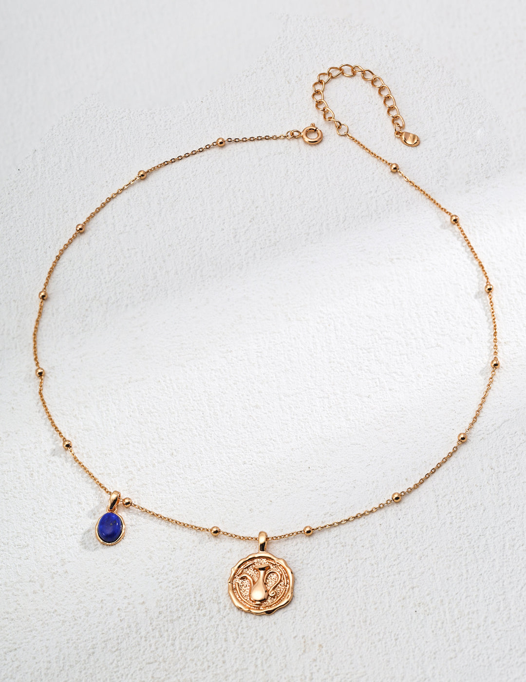 Mira Aura gold plated gemstone necklace with delicate beaded chain blue teardrop gemstone and coin pendant