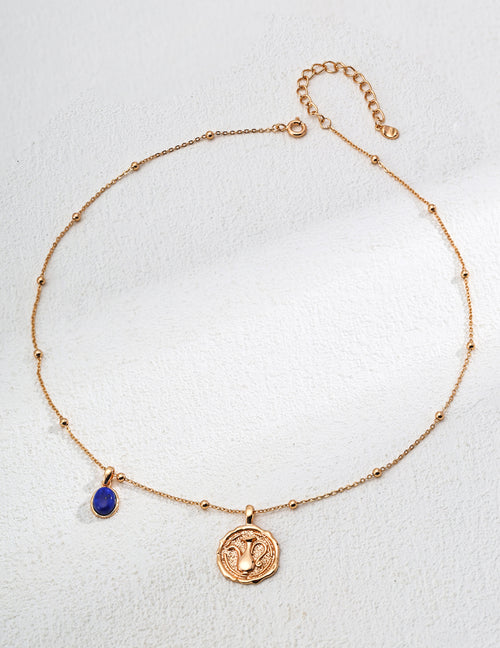 Mira Aura gold plated gemstone necklace with delicate beaded chain blue teardrop gemstone and coin pendant