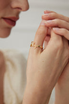 Mira Aura gold name ring on a womans hand closeup personalized script engraved jewelry gifts for her and him