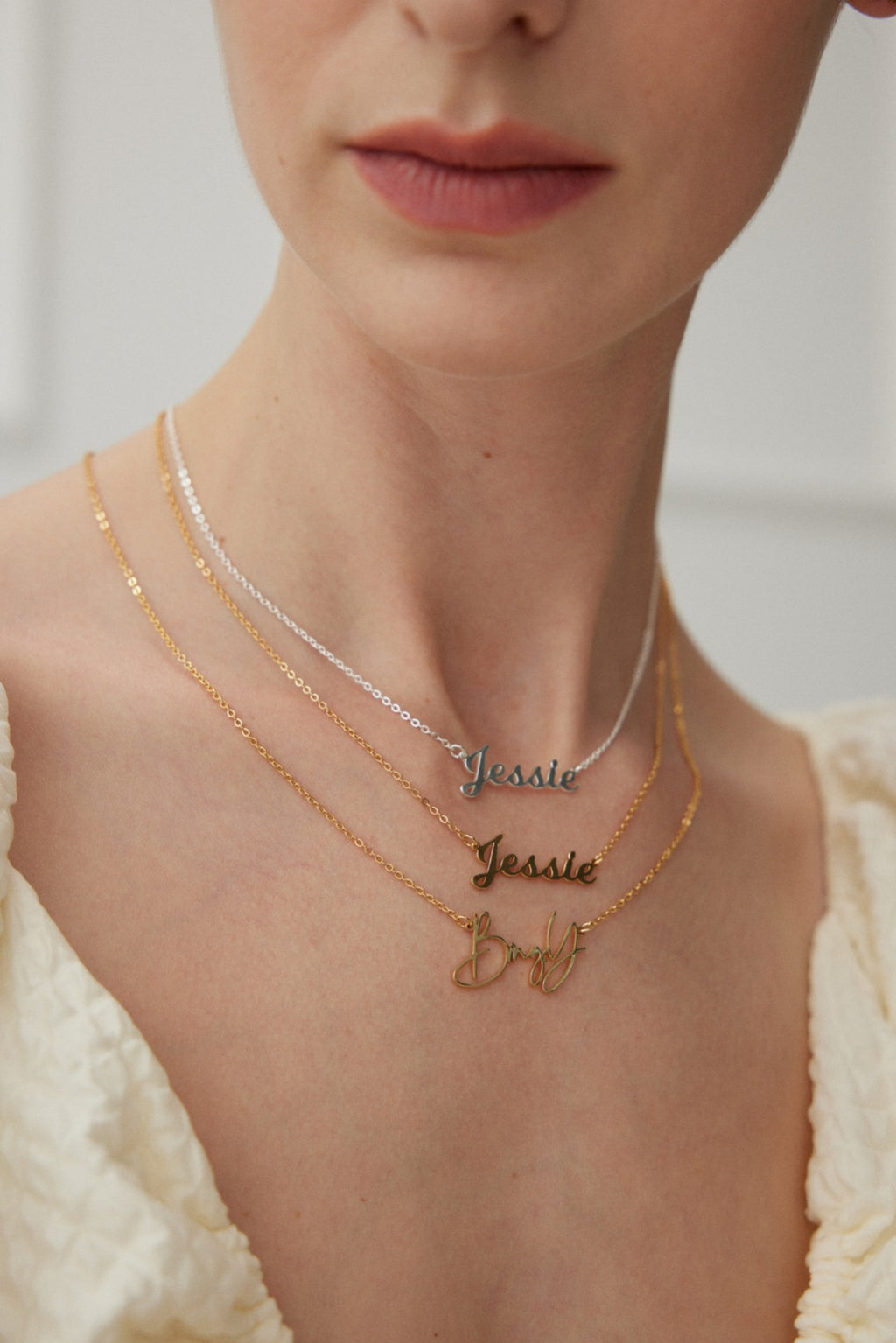 Layered personalized nameplate necklaces on a woman showing Mira Aura engraved jewelry gifts for her and him