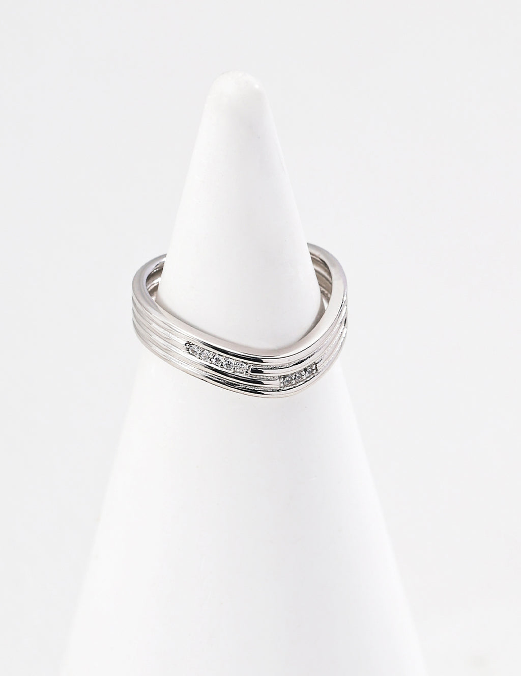 Gold plated adjustable ring for women with a sleek modern design displayed on a white ring holder