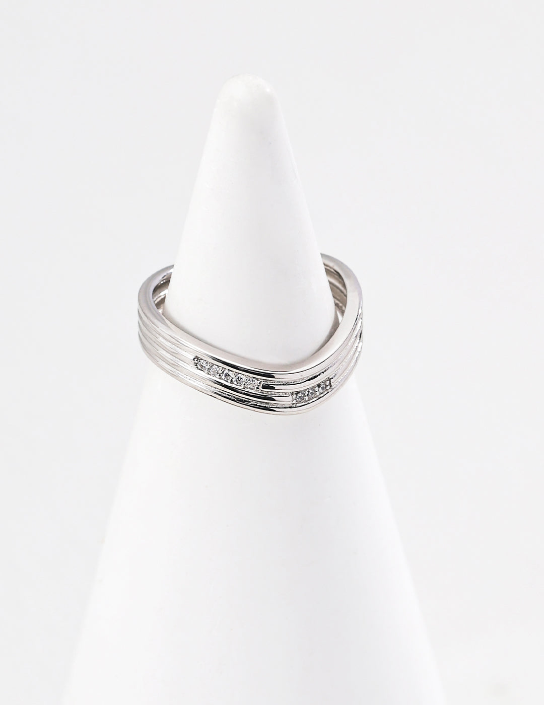 Gold plated adjustable ring for women with a sleek modern design displayed on a white ring holder