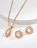 14k gold plated pearl studs paired with matching engraved oval pendant necklace on white background