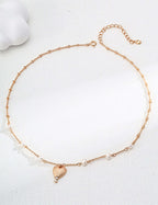 Mira Aura gold plated heart pendant necklace with delicate beaded chain and small pearl accents