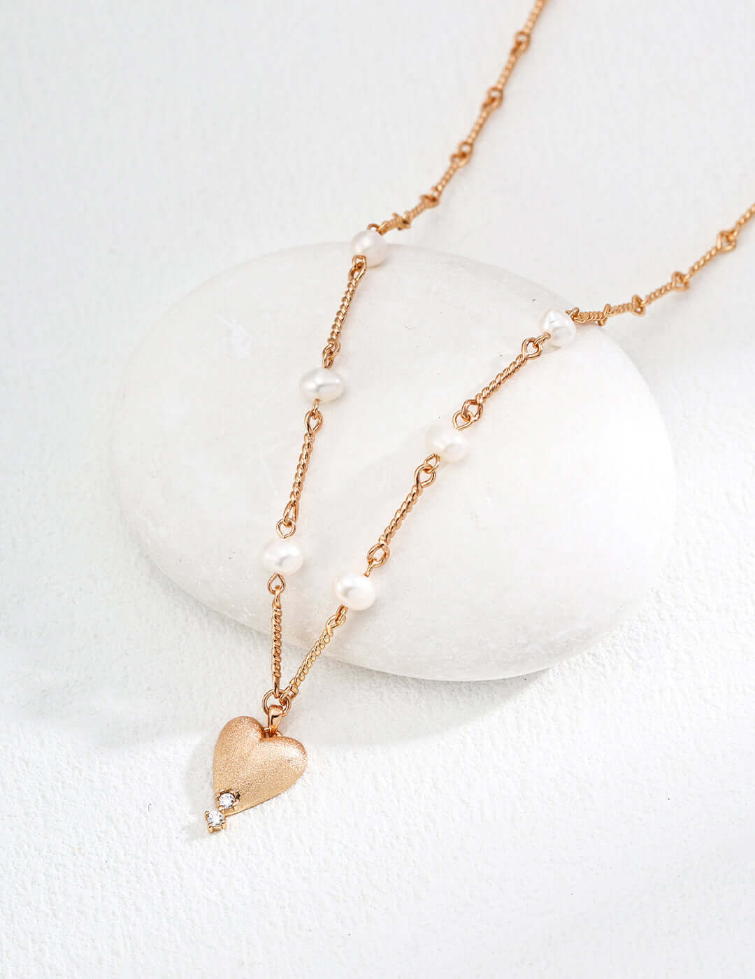 Mira Aura gold plated heart pendant necklace with textured heart charm small pearls and delicate chain