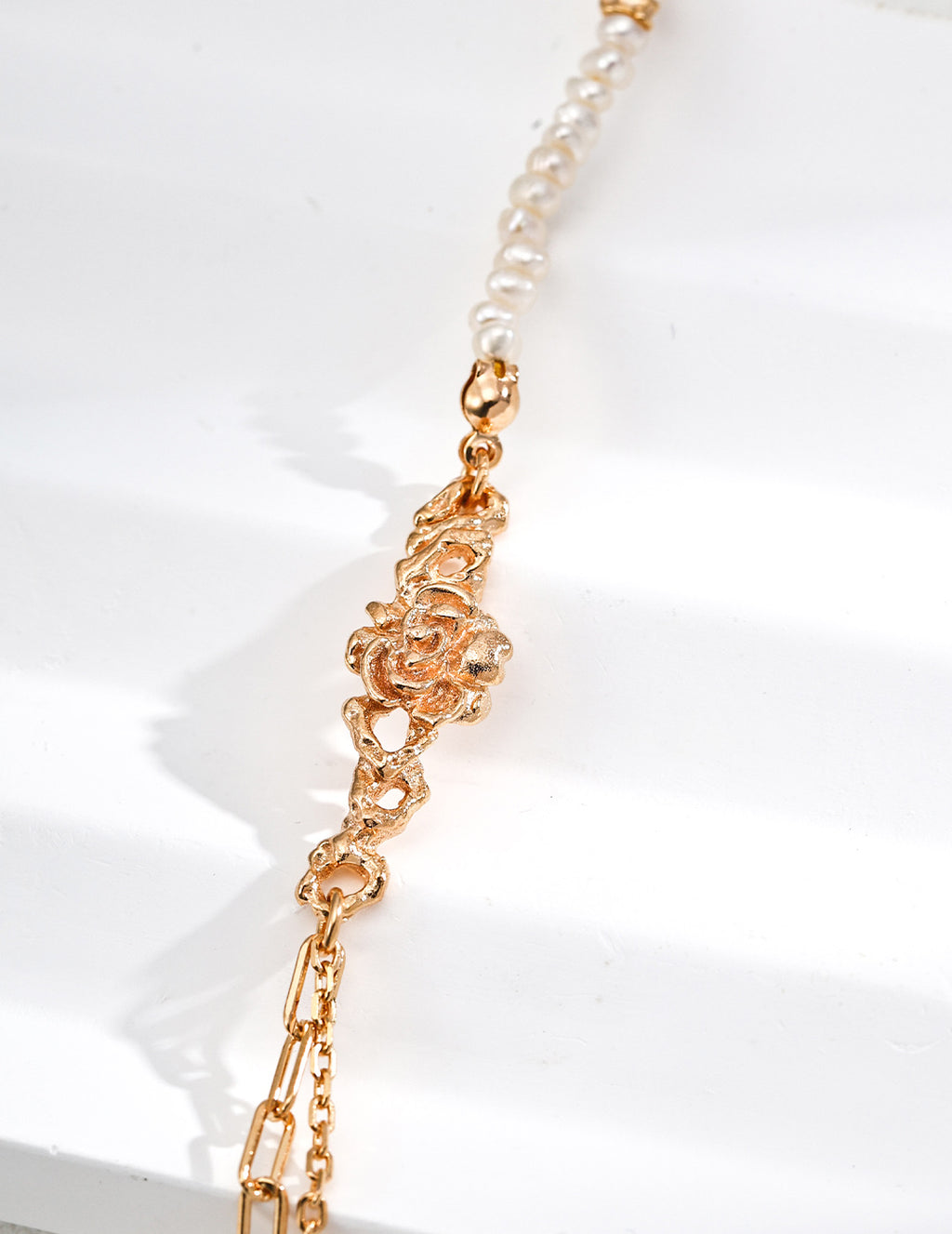 Mira Aura modern freshwater pearl bracelet with small irregular pearls and gold floral link centerpiece