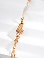 Mira Aura modern freshwater pearl bracelet with small irregular pearls and gold floral link centerpiece