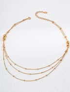 modern gold chain necklace Mira Aura triple layered delicate beaded chains with adjustable clasp on white