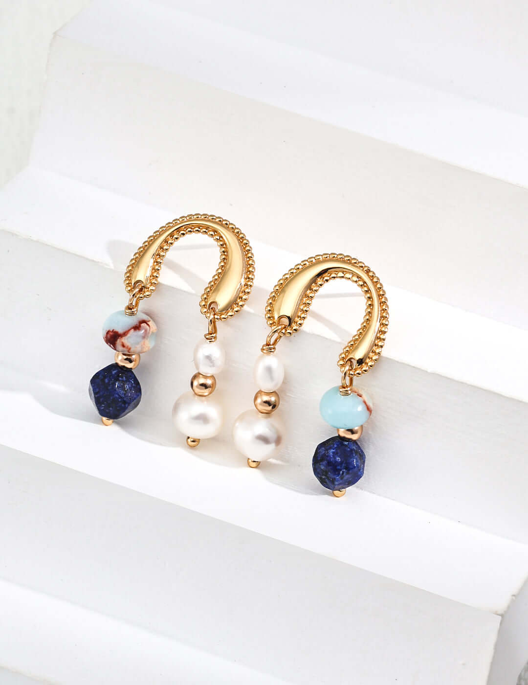 Mira Aura modern pearl gemstone earrings gold textured U hoops with dangling pearls lapis and aqua beads