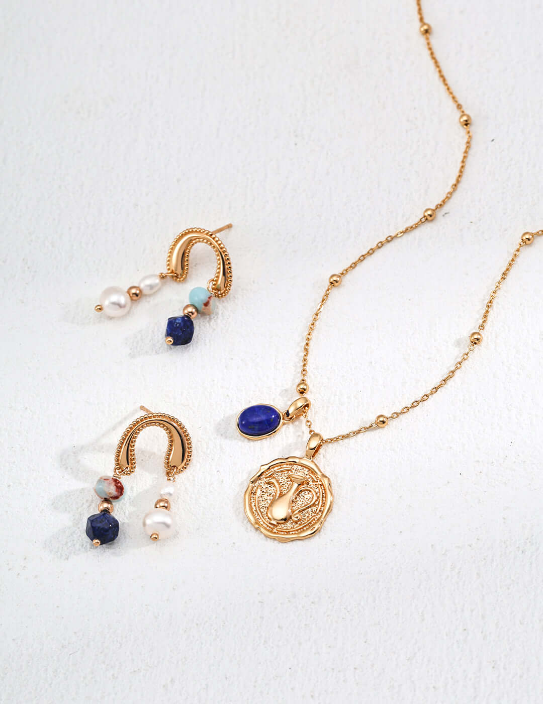 Mira Aura modern pearl gemstone earrings in gold with blue gemstone accents and textured hoops