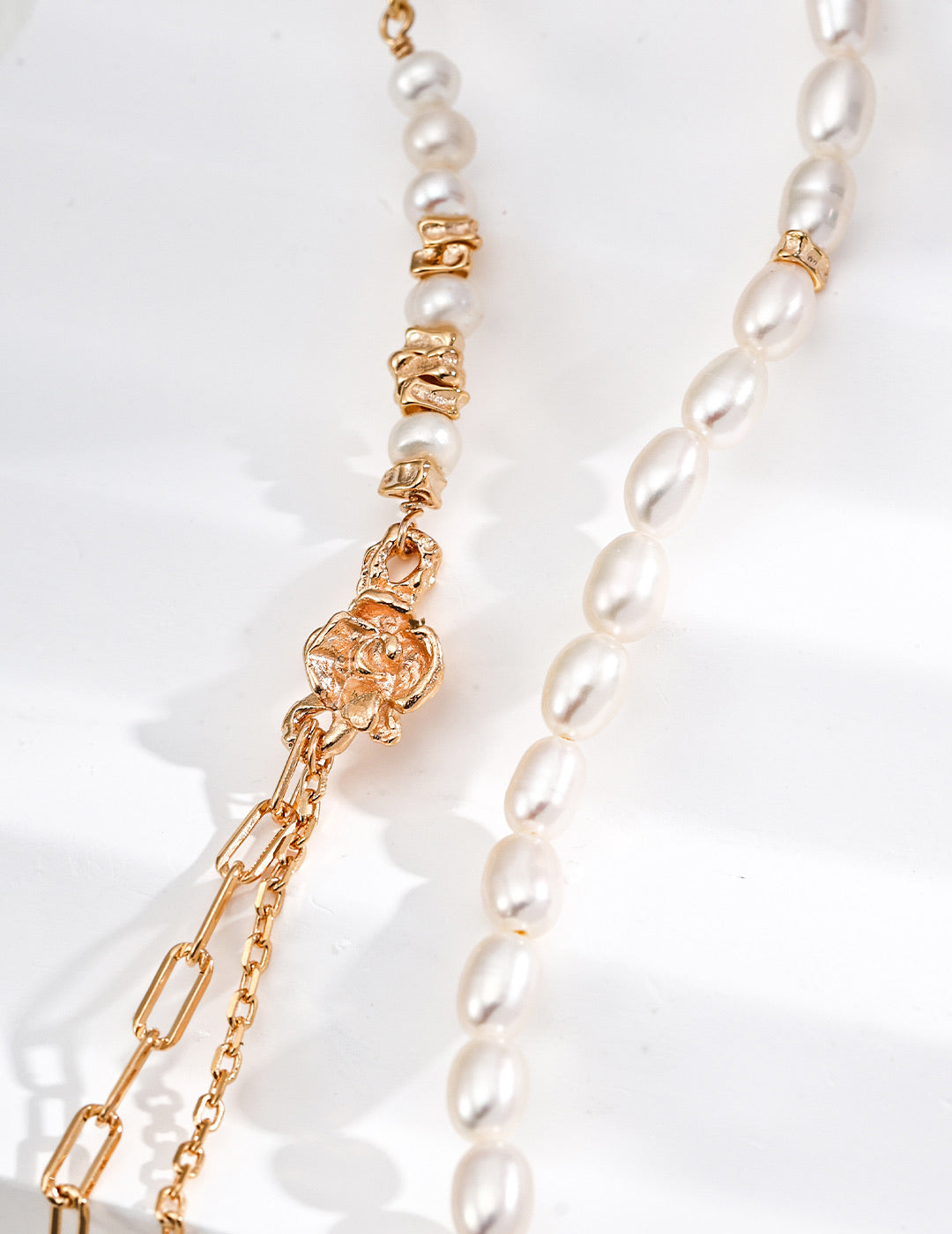 Mira Aura pacific pearl necklace close up of white freshwater pearls with gold floral clasp and chain