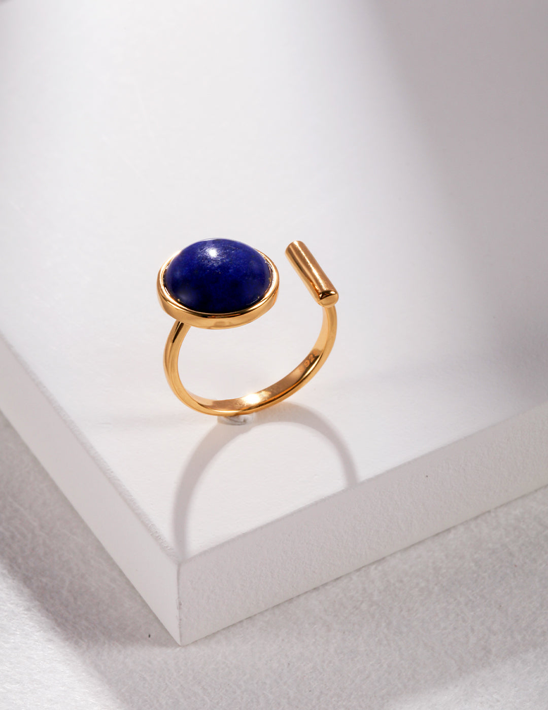 Gold ring with a large polished blue gemstone by Mira Aura modern gemstone bracelet women style
