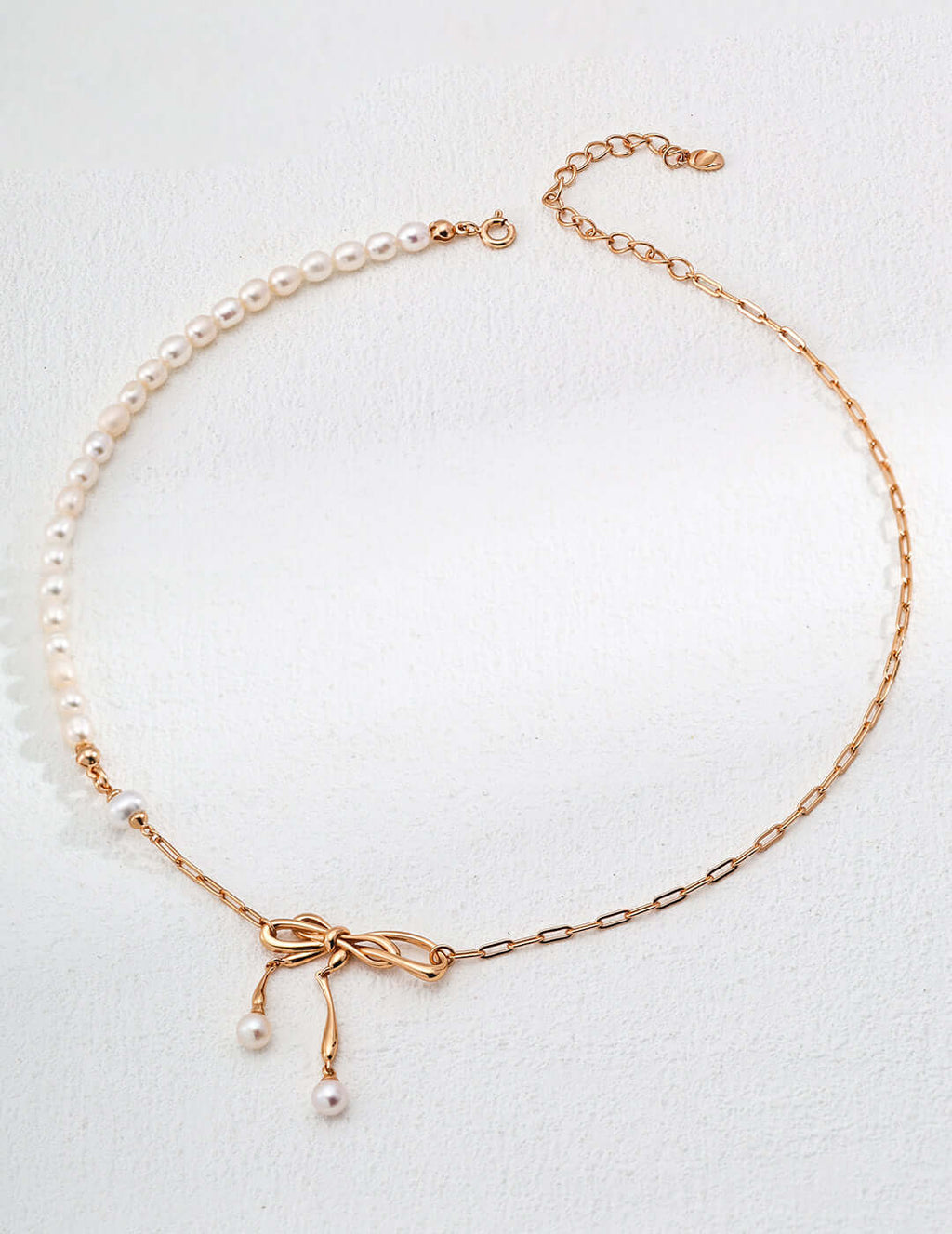 Mira Aura modern pearl jewelry gold necklace with half pearl strand delicate bow pendant and dangling pearls