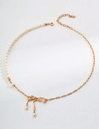 Mira Aura modern pearl jewelry gold necklace with half pearl strand delicate bow pendant and dangling pearls