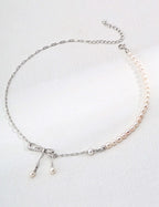 Mira Aura delicate necklace with half pearl strand silver chain and bow with dangling pearls modern pearl jewelry