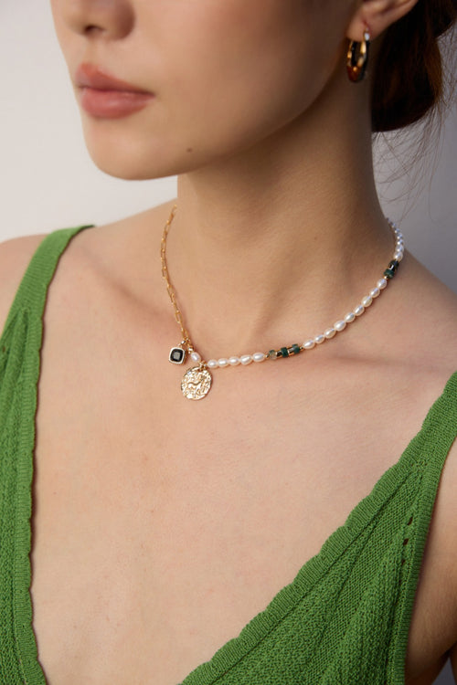 Mira Aura pearl and gemstone necklace for Aries with pearls gold chain green gems and coin pendant on model